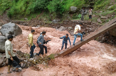 Villagers risk lives to cross river as bridge awaits completion for 5 ...
