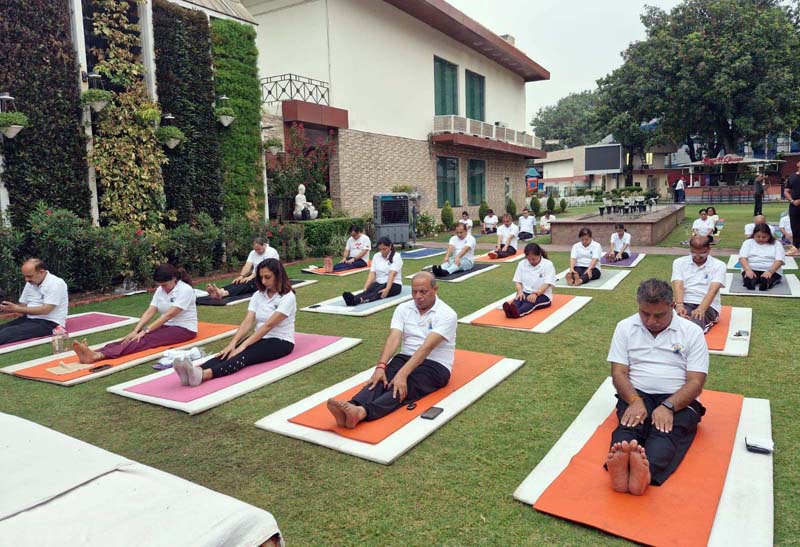 Jammu Club members performing yoga within the club premises on Saturday.